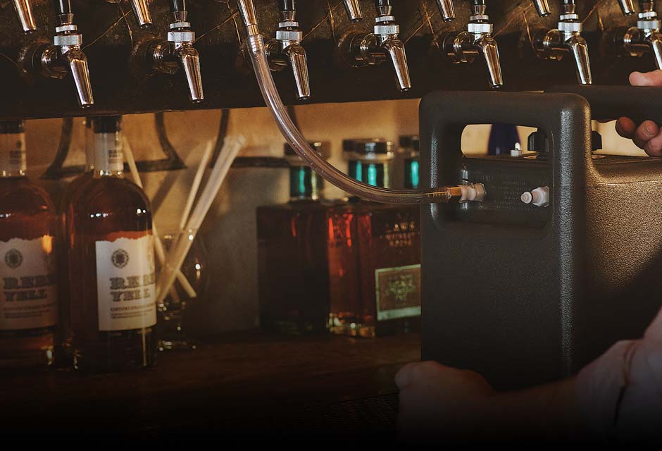 Close Up Of Individual Filling A BrewQube From A Tap